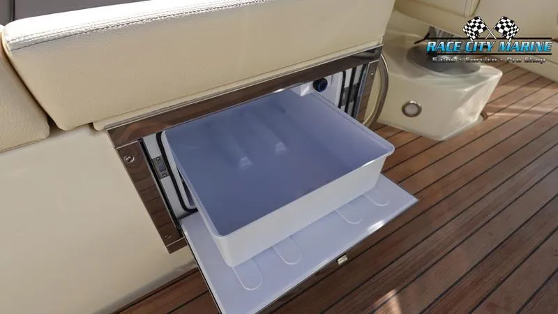 Slide: The Image of 2025 Chris-Craft 28GT boat interior with built-in cooler on teak deck. - 22