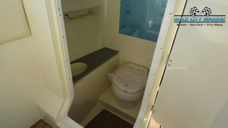 Slide: The Image of 2025 Chris-Craft 28GT boat bathroom interior with toilet and sink. - 32