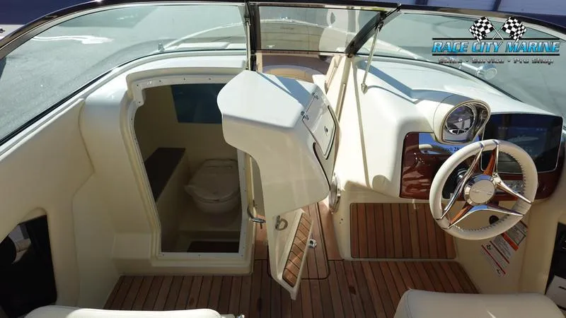 Slide: The Image of 2025 Chris-Craft 28GT boat interior with steering wheel and cabin entrance. - 33