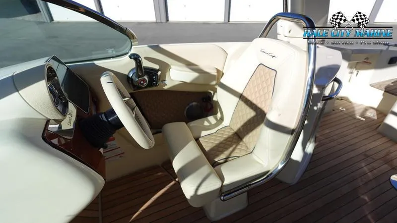 Slide: The Image of 2025 Chris-Craft 28GT boat interior with luxurious captain's seat and steering wheel. - 34