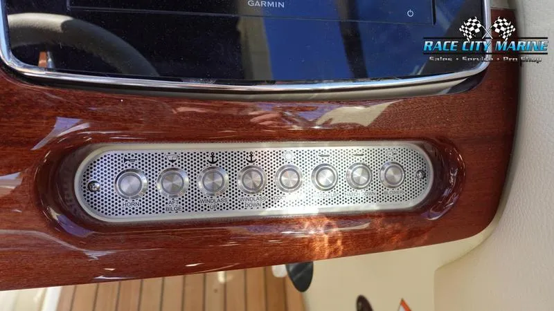 Slide: The Image of Dashboard of 2025 Chris-Craft 28GT boat with wood finish and control panel. - 39