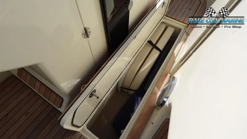 Slide: The Image of 2025 Chris-Craft 28GT boat storage compartment with wooden deck. - 43
