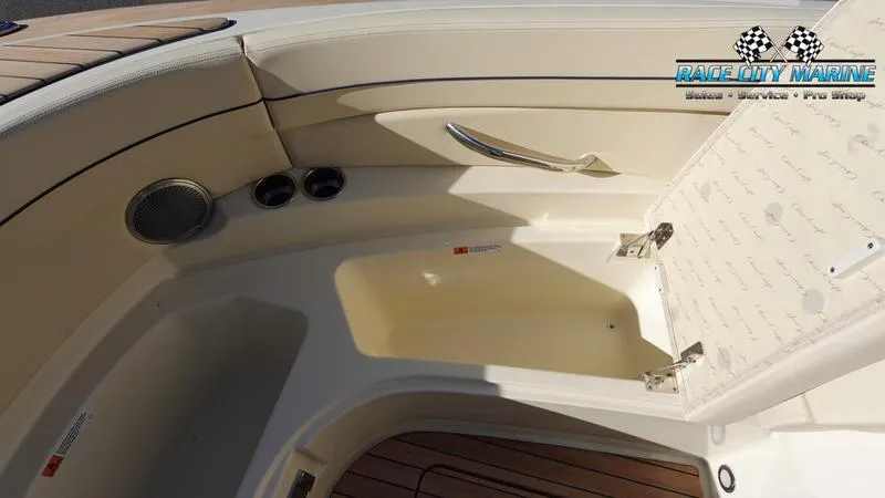 Slide: The Image of 2025 Chris-Craft 28GT boat interior with open storage compartment and wood flooring. - 46