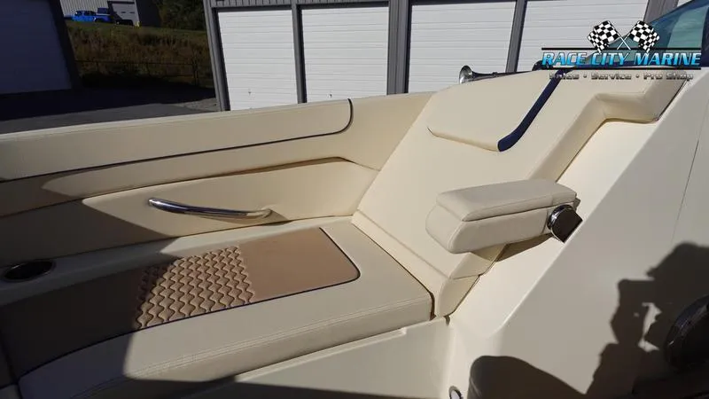 Slide: The Image of 2025 Chris-Craft 28GT boat interior with beige seating and armrest. - 48