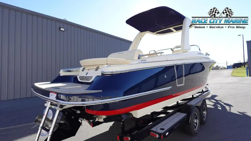 Slide: The Image of 2025 Chris-Craft 28GT boat on trailer, blue and white design, Race City Marine location. - 7