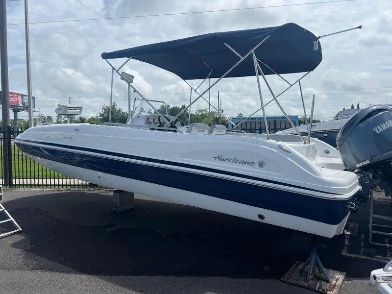 Slide: The Image of 2024 Hurricane Center Console SS 231 OB boat with canopy, displayed outdoors. - 0