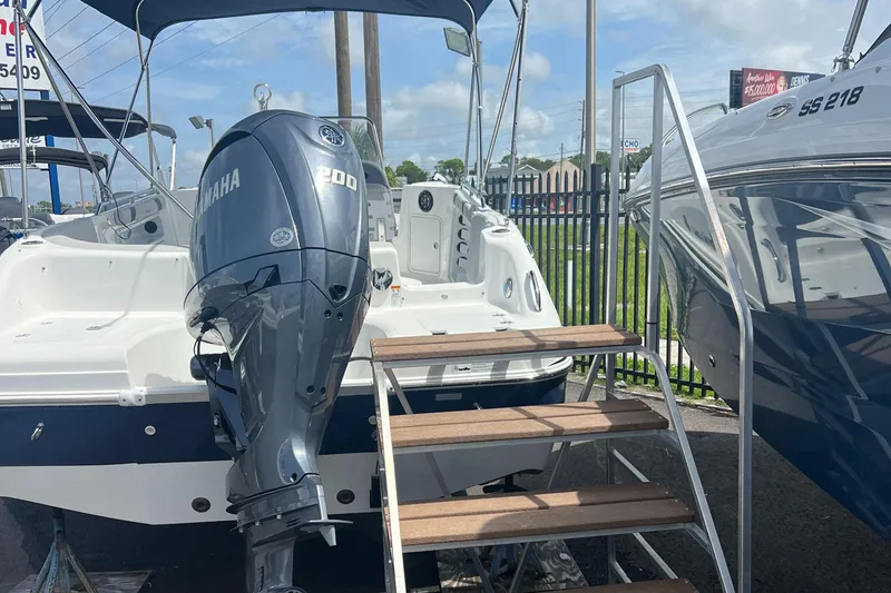 Slide: The Image of 2024 Hurricane Center Console SS 231 OB with Yamaha 200 engine, docked with stairs. - 1