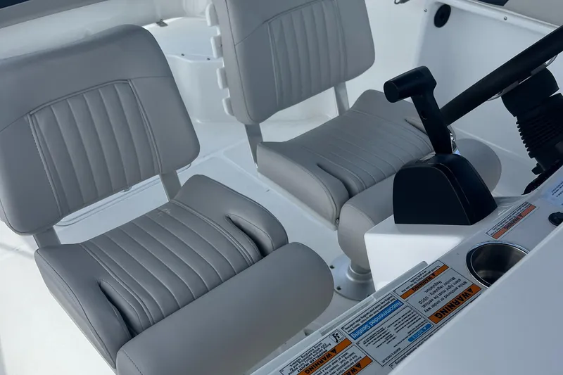 Slide: The Image of 2024 Hurricane Center Console SS 231 OB interior with dual gray seats and control panel. - 11