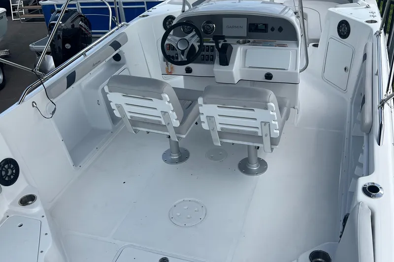 Slide: The Image of 2024 Hurricane Center Console SS 231 OB boat interior with dual seats and steering console. - 12
