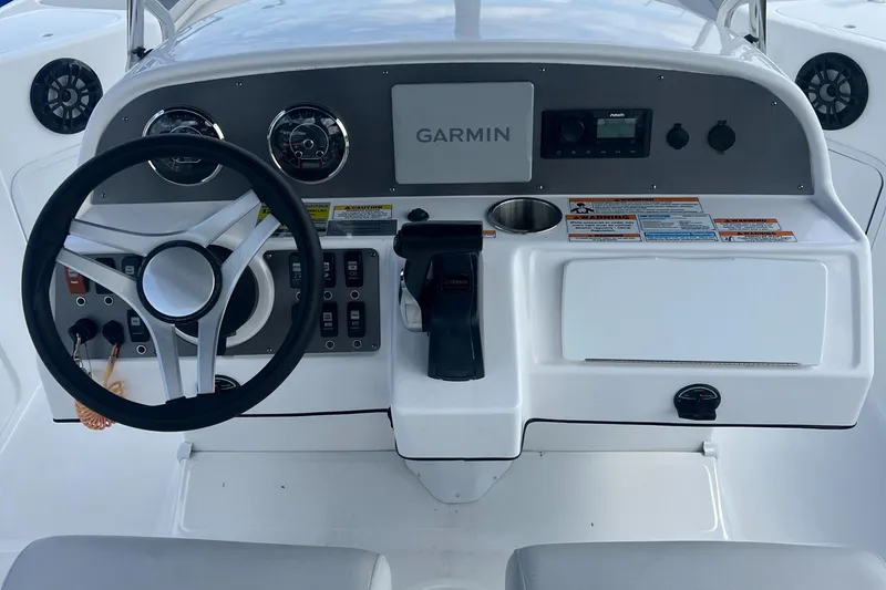 Slide: The Image of 2024 Hurricane Center Console SS 231 OB dashboard with Garmin navigation system. - 15