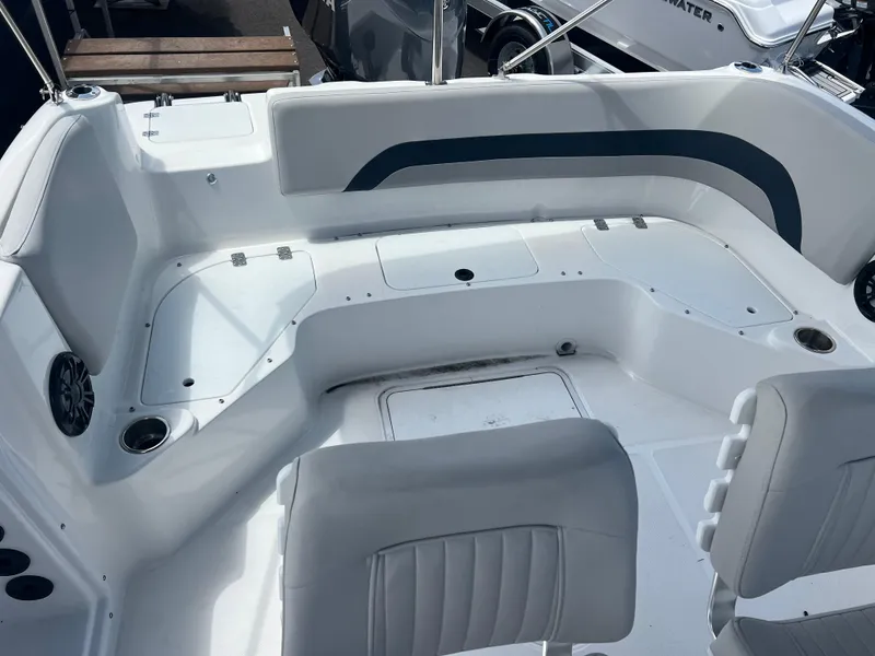 Slide: The Image of 2024 Hurricane Center Console SS 231 OB boat interior with white seating and cup holders. - 3