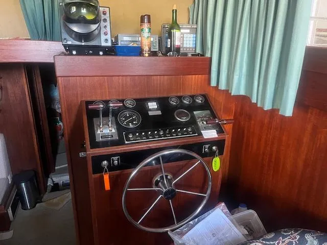 Slide: The Image of 1981 Viking 43 DC boat helm with steering wheel and control panel. - 10