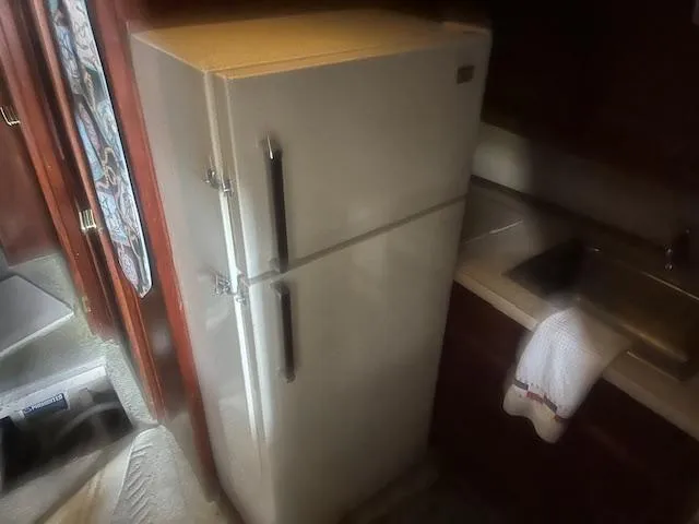 Slide: The Image of 1981 Viking 43 DC kitchen with refrigerator and sink. - 13