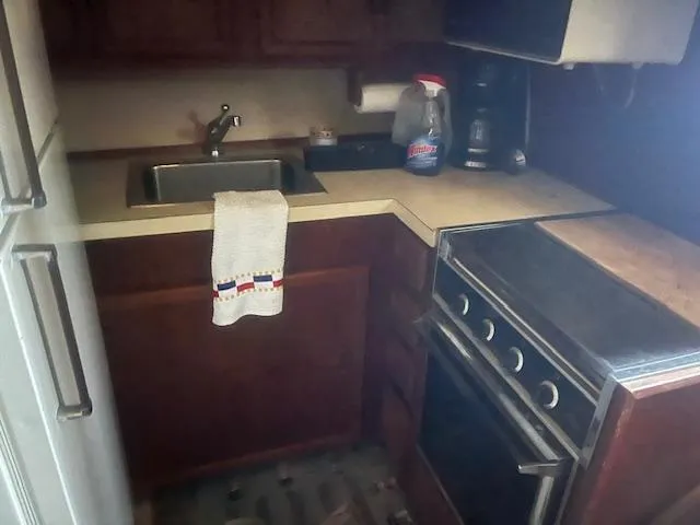 Slide: The Image of 1981 Viking 43 DC kitchen with stove, sink, and wooden cabinets. - 14