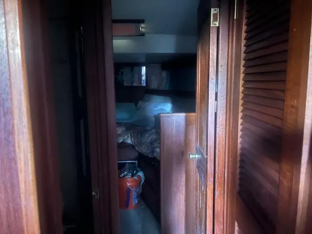 Slide: The Image of Interior cabin of 1981 Viking 43 DC yacht with wooden paneling and cozy bedding. - 15