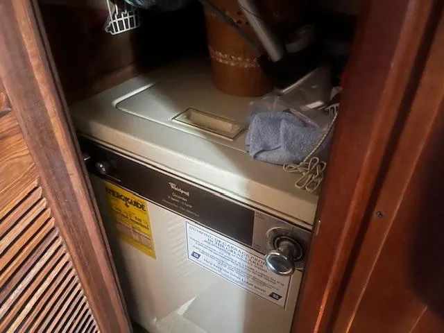 Slide: The Image of Compact laundry area inside 1981 Viking 43 DC boat with Whirlpool appliance. - 16
