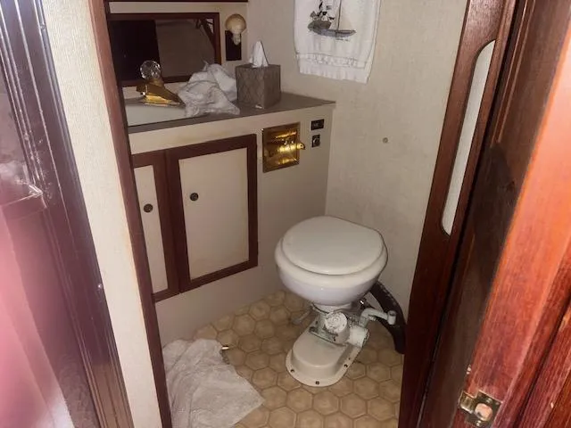 Slide: The Image of 1981 Viking 43 DC bathroom with toilet, sink, and wooden cabinetry. - 17