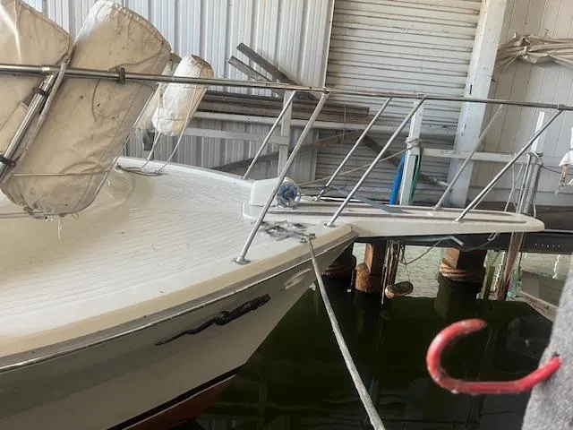 Slide: The Image of 1981 Viking 43 DC boat docked in a marina with life preservers. - 2