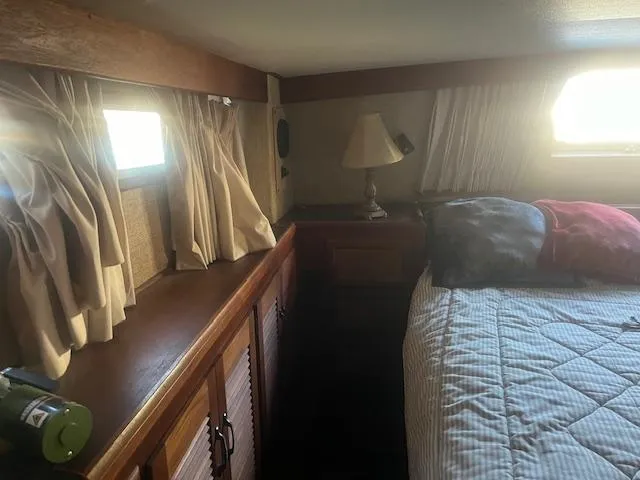 Slide: The Image of Cozy bedroom interior of 1981 Viking 43 DC yacht with wooden cabinets and soft lighting. - 20