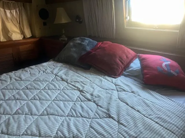 Slide: The Image of Cozy bedroom in 1981 Viking 43 DC yacht with quilted bedding and pillows. - 22