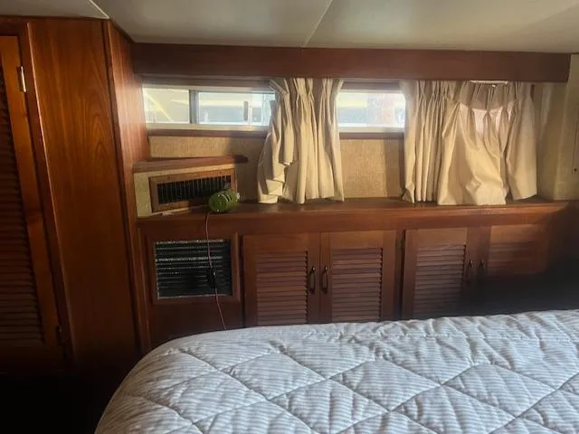 Slide: The Image of Interior of 1981 Viking 43 DC yacht with wood paneling and curtained windows. - 23