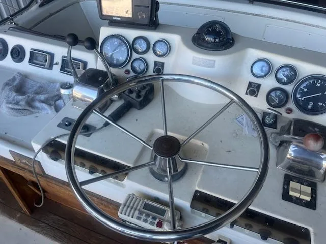 Slide: The Image of 1981 Viking 43 DC boat helm with steering wheel and navigation instruments. - 29