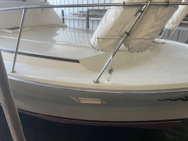 Slide: The Image of 1981 Viking 43 DC yacht in a marina, featuring a sleek white deck and railing. - 3