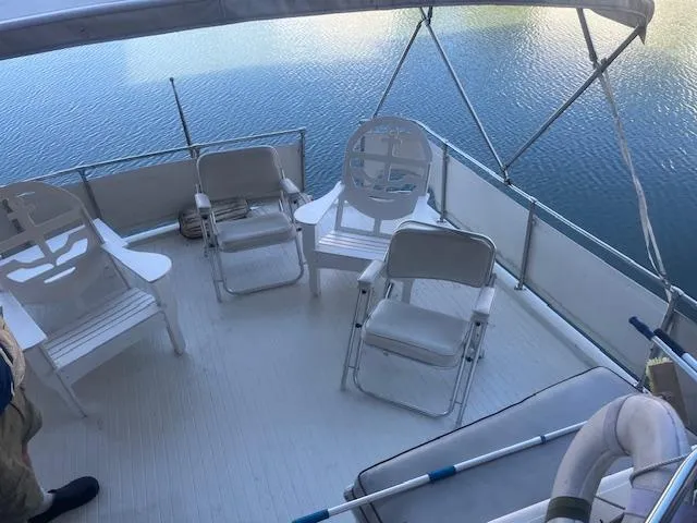 Slide: The Image of 1981 Viking 43 DC boat deck with chairs overlooking calm water. - 31