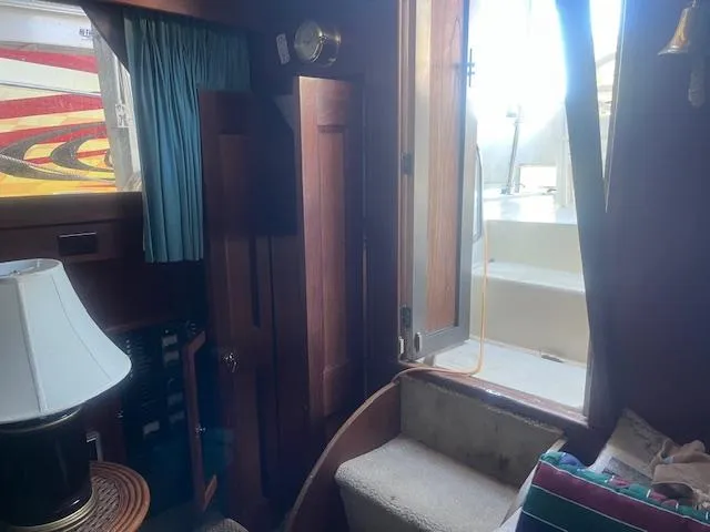 Slide: The Image of Interior of 1981 Viking 43 DC yacht with wooden cabinetry and open door to deck. - 8