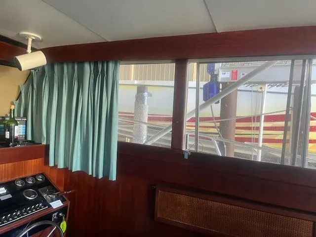 Slide: The Image of Interior of 1981 Viking 43 DC boat with green curtains and control panel. - 9