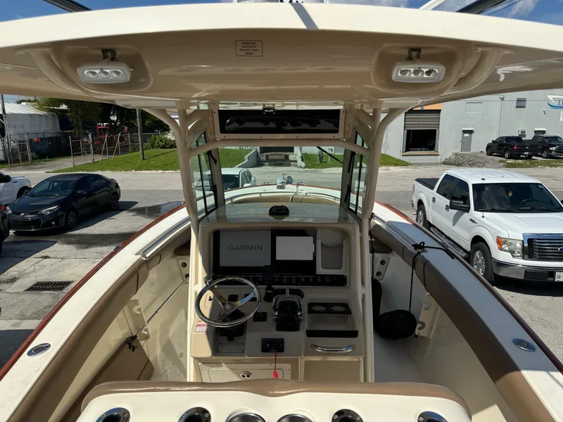 Slide: The Image of 2013 Scout 275 LXF boat cockpit with Garmin navigation system and steering wheel. - 11