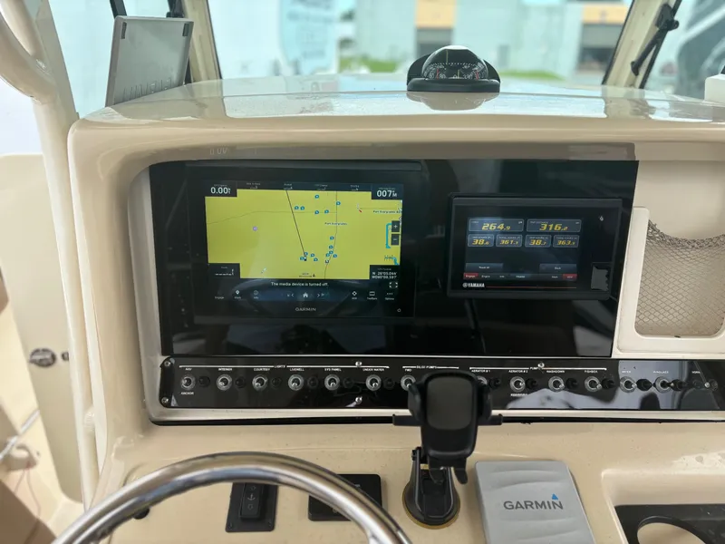Slide: The Image of 2013 Scout 275 LXF boat dashboard with Garmin navigation system and controls. - 15