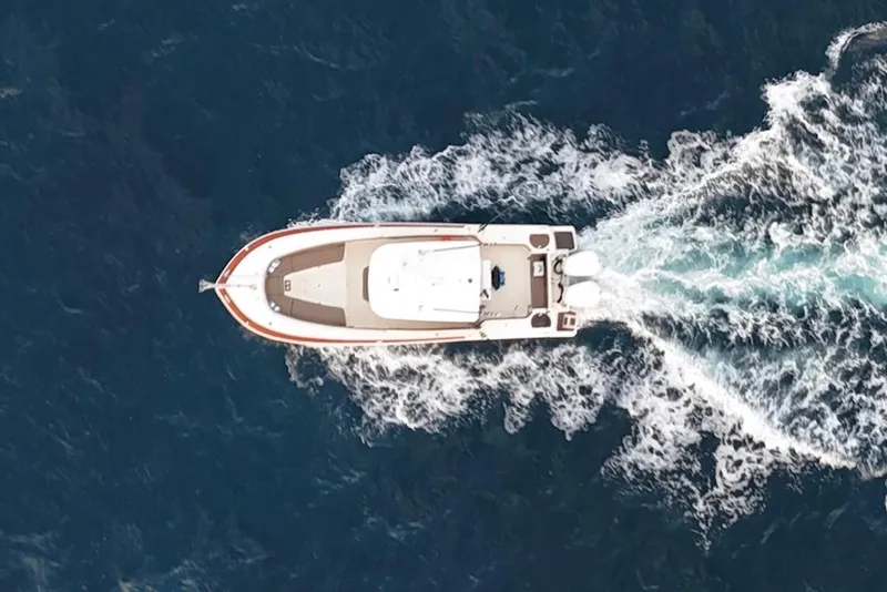 Slide: The Image of Aerial view of 2013 Scout 275 LXF boat cruising through blue ocean waters. - 2