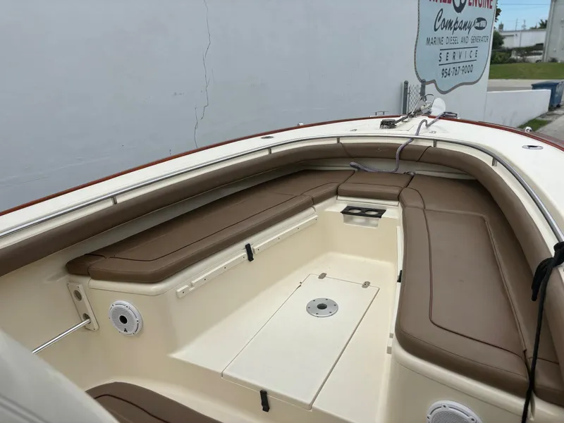 Slide: The Image of 2013 Scout 275 LXF boat interior with tan seating and white deck. - 8