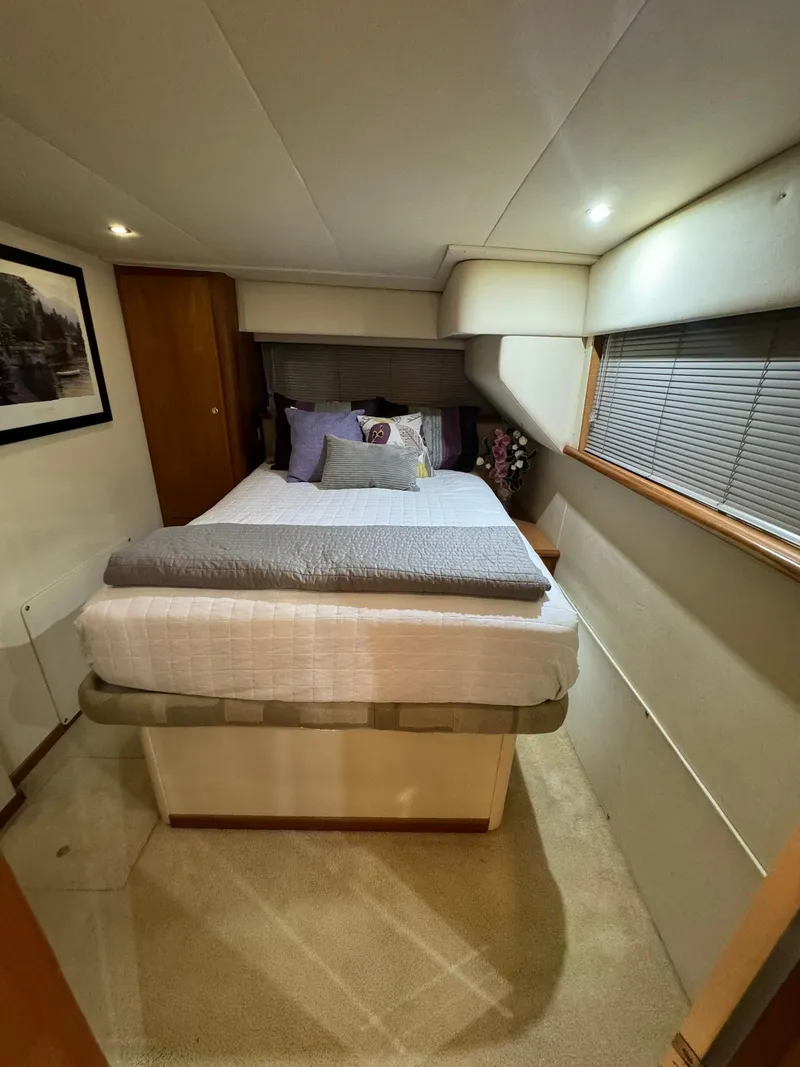Slide: The Image of Cozy bedroom interior of 1989 Sea Ray 39 yacht with bed and soft lighting. - 18