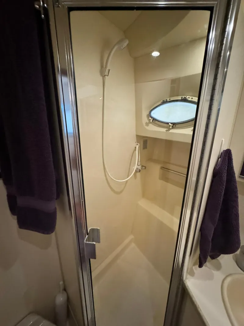 Slide: The Image of Shower area in 1989 Sea Ray 39 boat with porthole and handheld showerhead. - 24