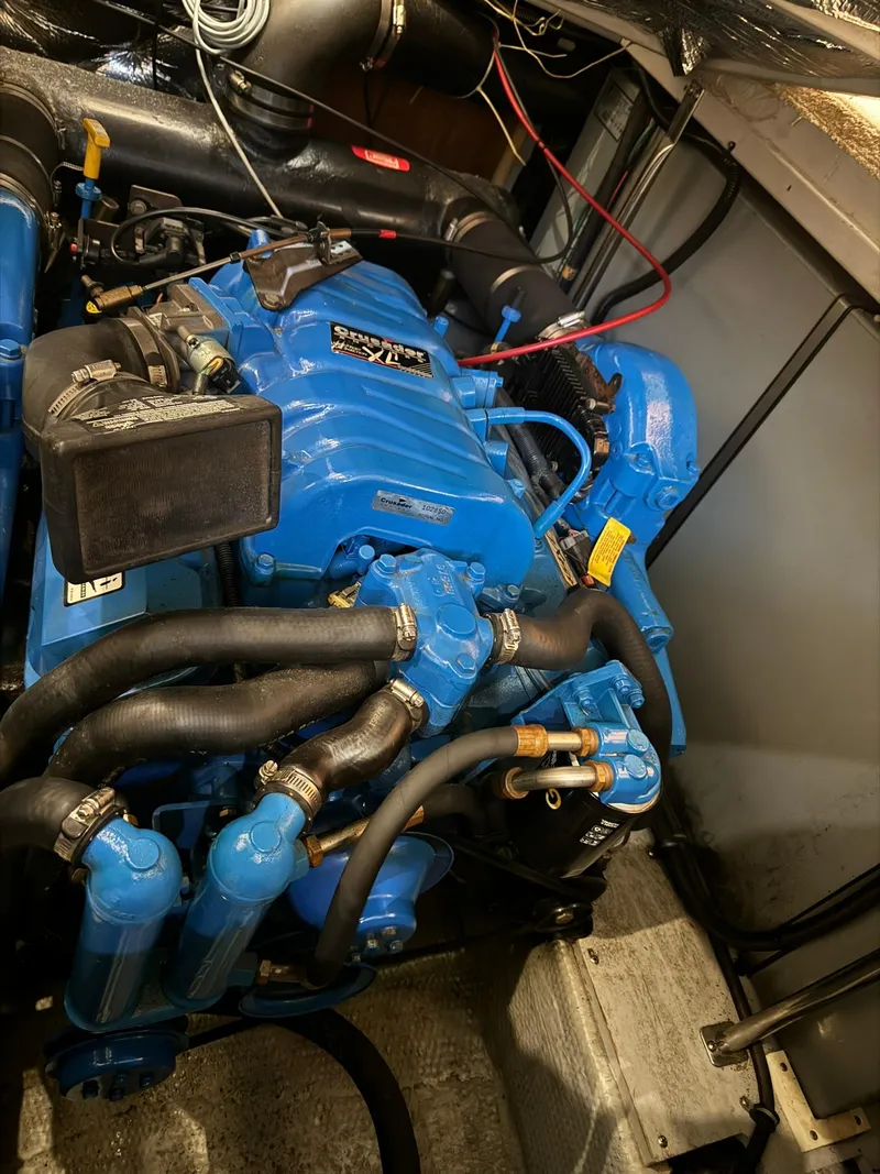 Slide: The Image of Engine compartment of a 1989 Sea Ray 39 boat, featuring a blue marine engine. - 27