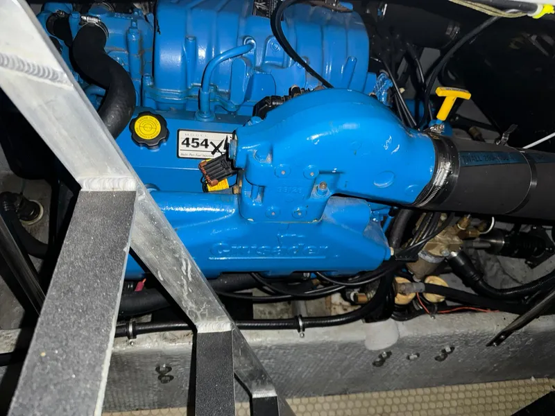 Slide: The Image of Engine compartment of a 1989 Sea Ray 39 boat, featuring a blue 454X model engine. - 29