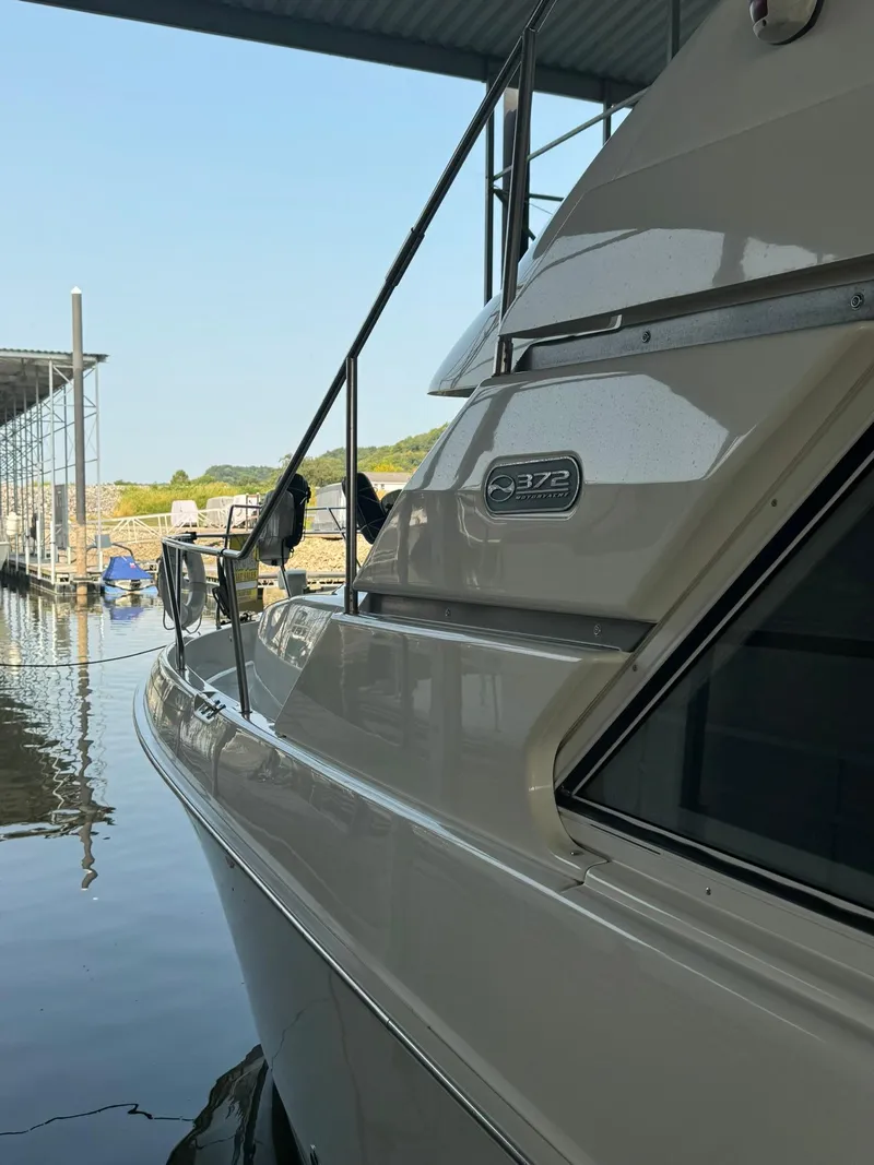Slide: The Image of 1989 Sea Ray 39 boat docked in a marina, side view. - 35