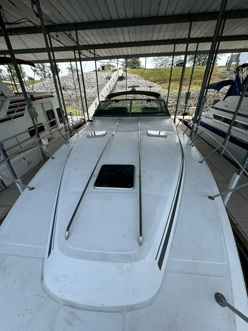 Slide: The Image of 1989 Sea Ray 39 boat docked under a covered marina. - 39