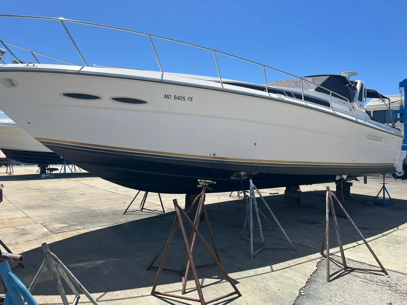 Slide: The Image of 1989 Sea Ray 39 boat on stands in a marina under clear blue sky. - 4