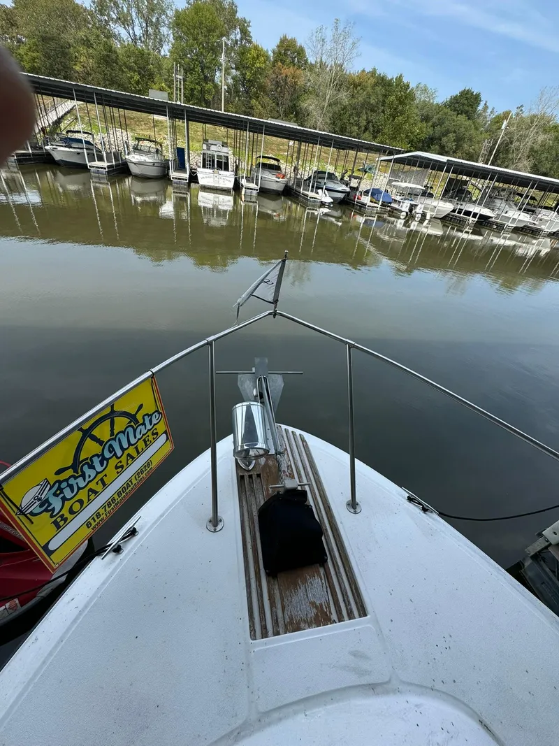 Slide: The Image of Bow view of 1989 Sea Ray 39 at marina with boats docked in background. - 40