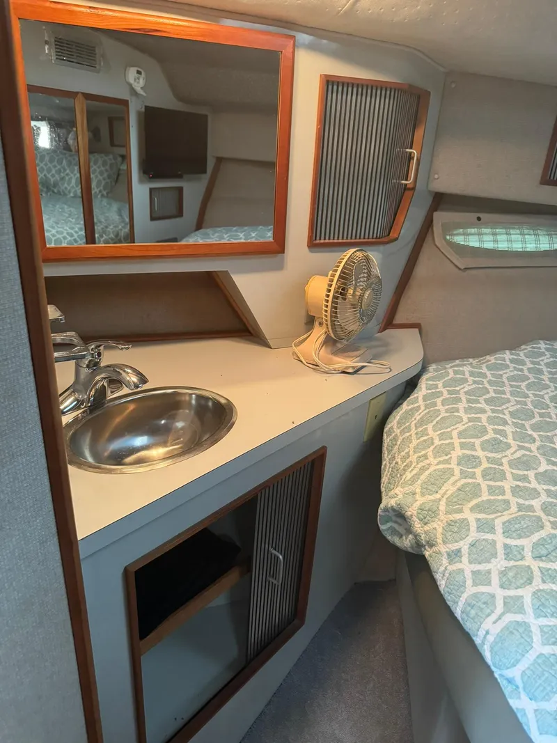 Slide: The Image of Interior of 1989 Sea Ray 39 boat with sink, fan, and bed. - 42
