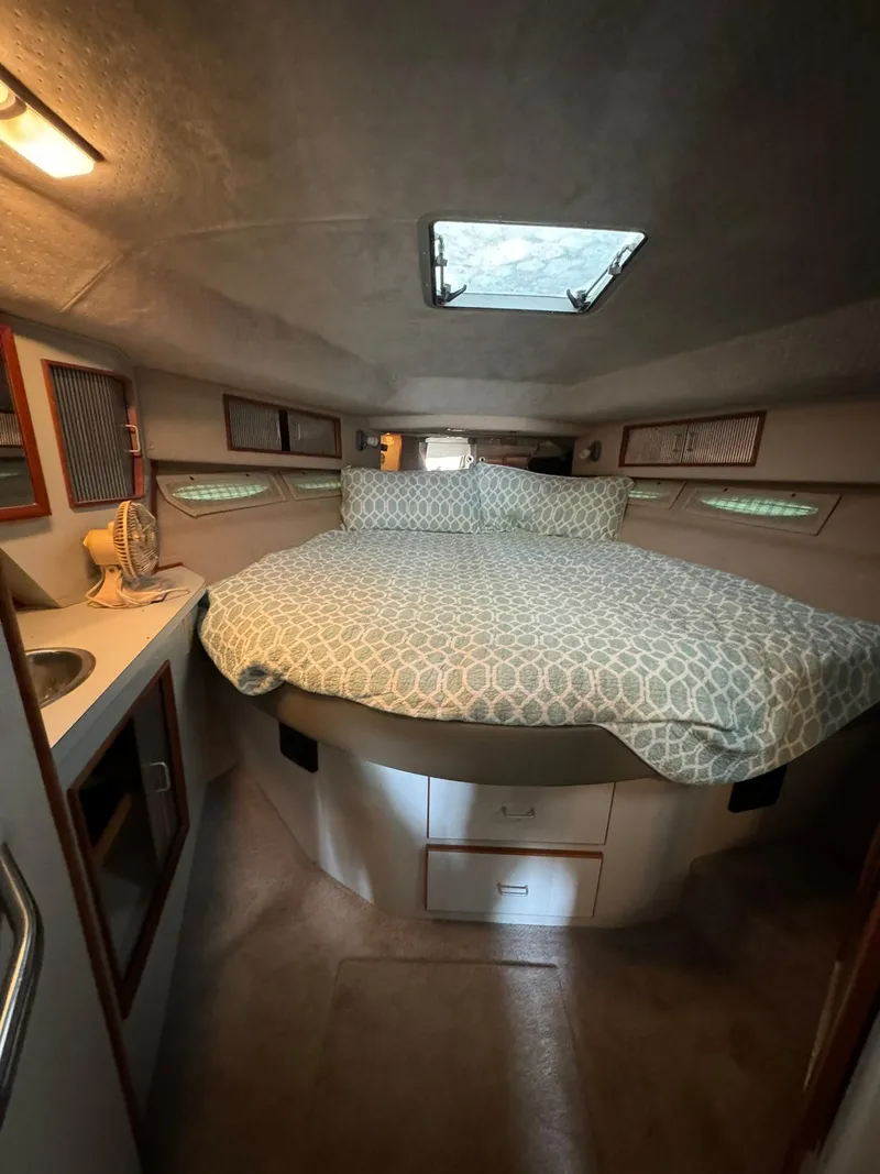 Slide: The Image of Cozy cabin interior of 1989 Sea Ray 39 boat with bed and storage. - 43