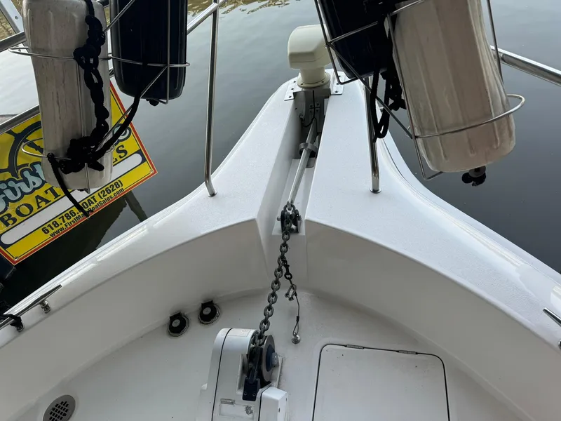 Slide: The Image of 1989 Sea Ray 39 boat bow with anchor chain and fenders, docked near water. - 7