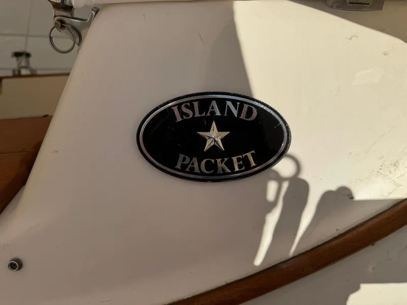 Slide: The Image of Island Packet 40 sailboat emblem, 1998 model, featuring a star design. - 18