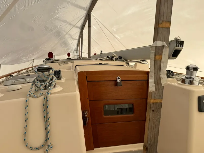 Slide: The Image of 1998 Island Packet 40 sailboat cockpit under protective cover. - 19