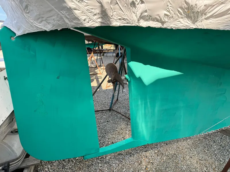 Slide: The Image of 1998 Island Packet 40 sailboat hull in dry dock, showing keel and rudder. - 2