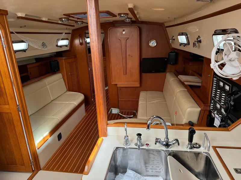 Slide: The Image of Interior of 1998 Island Packet 40 sailboat with wood finish and seating area. - 20