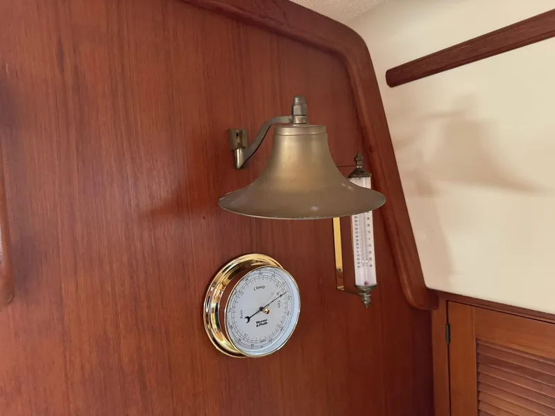 Slide: The Image of Brass lamp and barometer on Island Packet 40 yacht's wooden interior, 1998 model. - 25